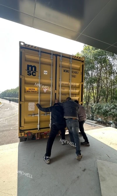 The workers of Maxwell are working hard to load the goods The workers of Maxwell are working hard to load the goods
