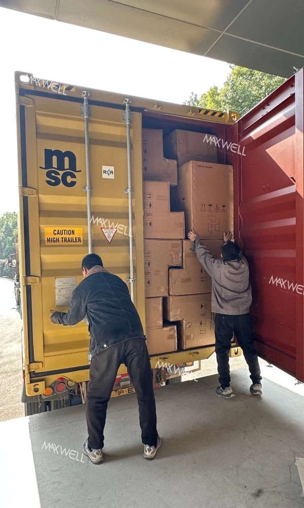 The workers of Maxwell are working hard to load the goods The workers of Maxwell are working hard to load the goods